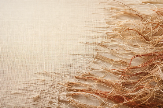 A smooth aligned surface giving way to frizz and wear.